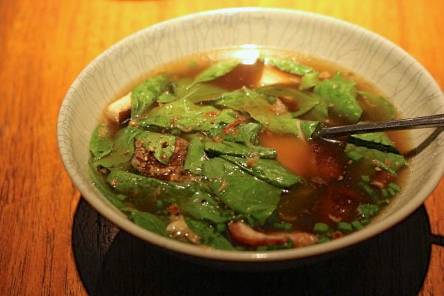 Clear soup of roast duck with Thai basil and young coconut.